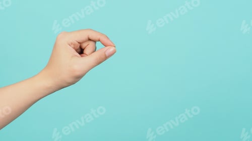 Preview: Empty Hand holding or catch nothing guesture on green and blue or mint background.