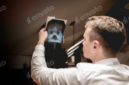 Preview: back view of person hold skull scan in the clinic