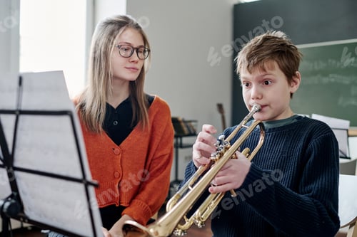 Preview: Boy Playing Trumpet At Music Class