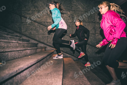 Preview: Three women running in the night in the city center