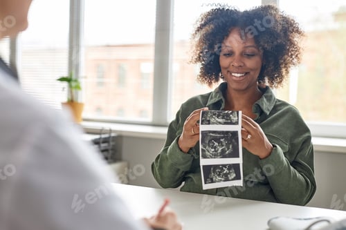 Preview: Happy Pregnant Woman Holding Ultrasonography Picture