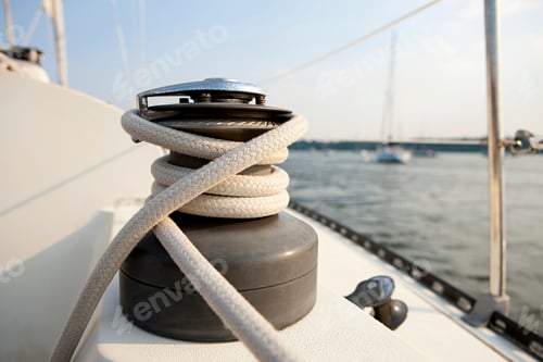 Preview: Closeup of a winch and rope on the deck of a sailboat with blurred maritime background