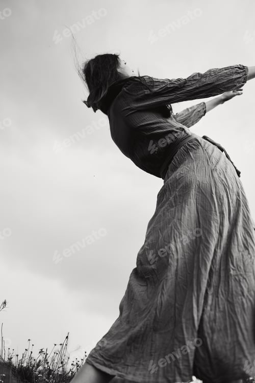 Preview: beautiful woman in dress gesturing with hands posing black and white photo