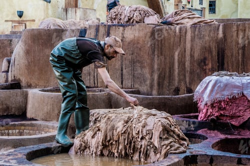 Preview: Marrakesh, Morocco - December 12, 2017: Man preparing animal skin