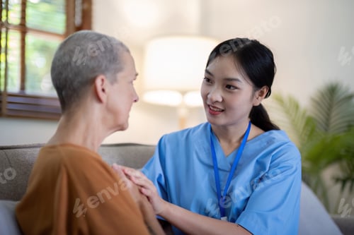 Vista previa: Asian caregiver holding hands with elderly woman at home. Concept of elderly care and emotional