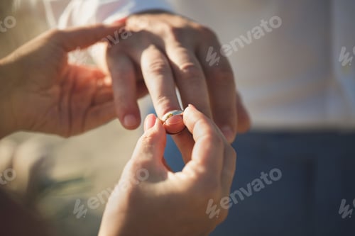 Preview: bride wears a ring on the groom's finger