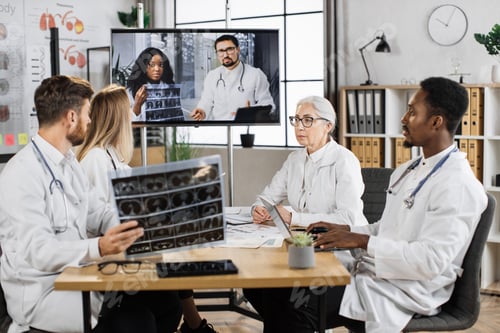 Preview: Scientists examining MRI result during online call indoor