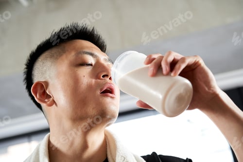 Preview: Asian men drinking protein after training