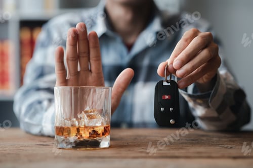 Preview: Man holding a glass of brandy, he is drinking brandy in a bar.