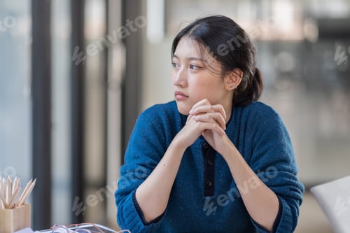 Preview: Portrait of tired young business Asian woman work with documents tax laptop computer in office. Sad,