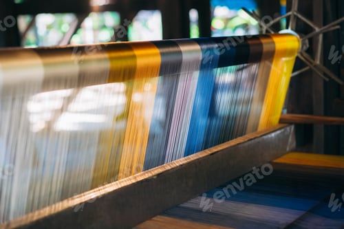 Preview: Silk thread from weaving machine traditional craft, a vibrant tapestry of color.