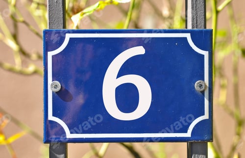 Preview: Closeup shot of a blue sign with the number 6 on the blurry background