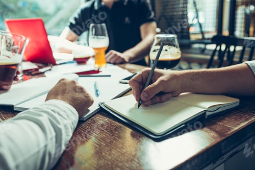 Preview: Young cheerful people smile and gesture while relaxing in pub.