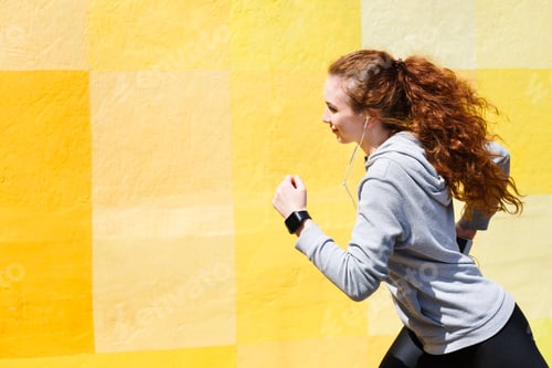 Preview: Side View Of Female Athlete Running Against Bright Colorful Graffiti Wall, Copy Space