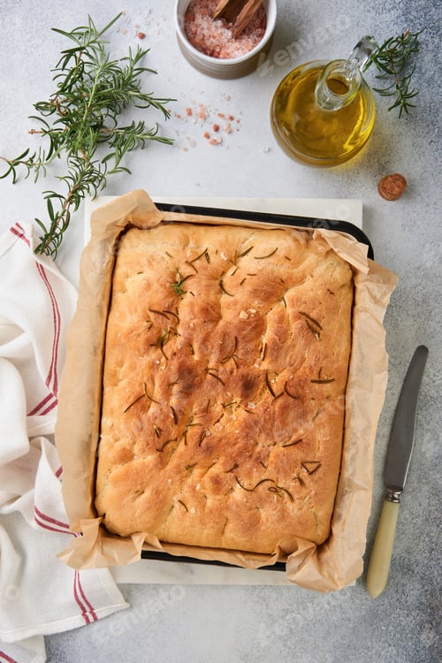 Preview: Focaccia. Italian traditional bread and recipe baking with aromatic seasonings and rosemary on old c