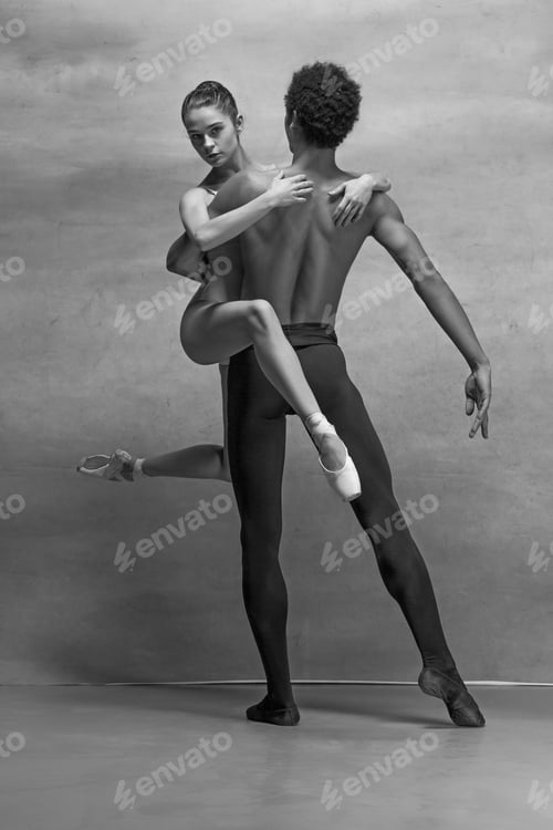 Preview: Couple of ballet dancers posing over gray background