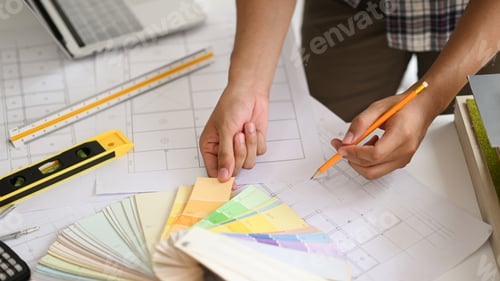 Preview: A young man holding a color chart, a young architect chooses a color chart for home design.
