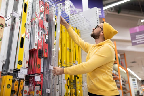 Preview: young man buys a building bubble level