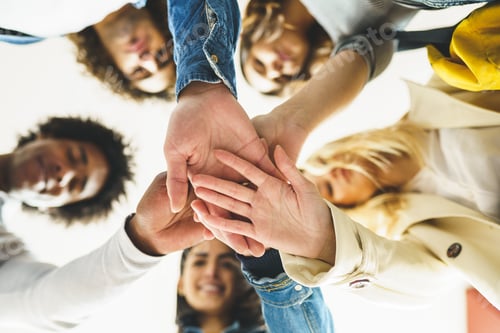 Preview: Hands of a multi-ethnic group of friends joined together as a sign of support and teamwork
