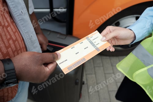 Preview: Hand of African passenger passing his ticket to conductor