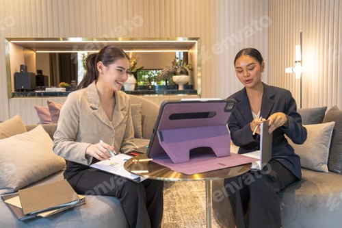 Preview: Business friends working together in the common area of the condo.