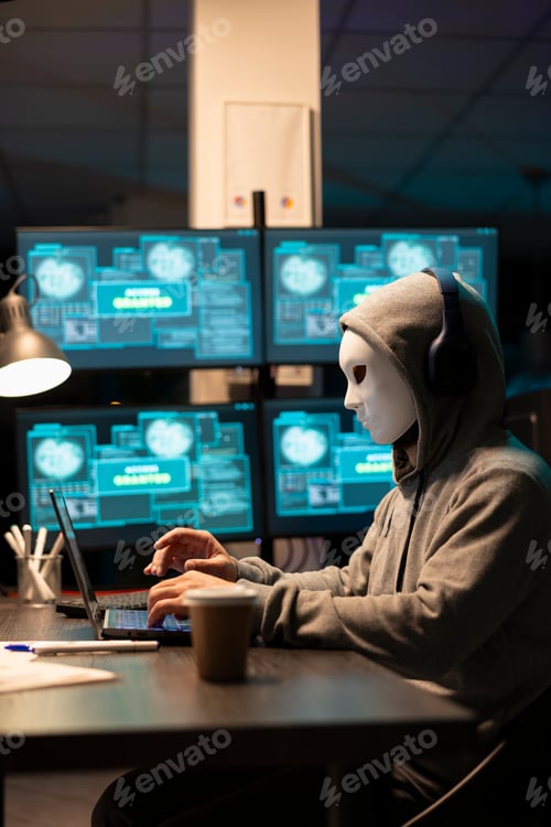 Preview: Anonymous person with headphones creating malware code on devices