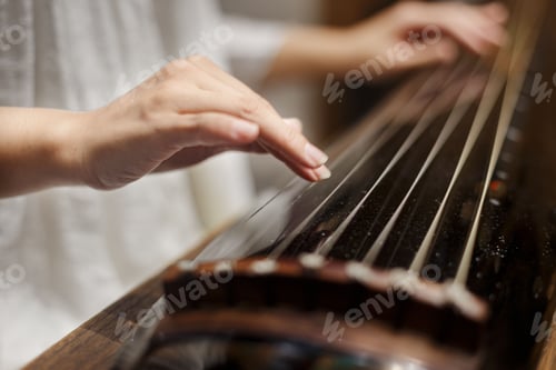Preview: Female playing guqin, a plucked seven-string Chinese musical instrument
