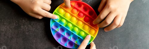 Preview: kids anti stress sensory pop it or simple dimple fidget push toys in kid's hands. playing with a toy