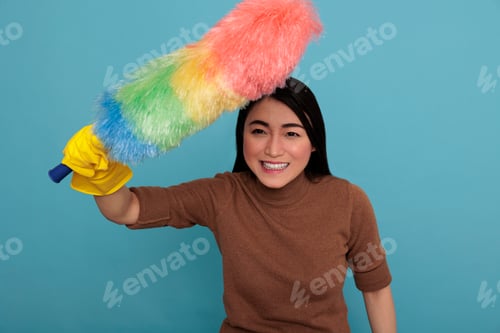 Preview: Smiling glad and laughing young asian housekeeper at work
