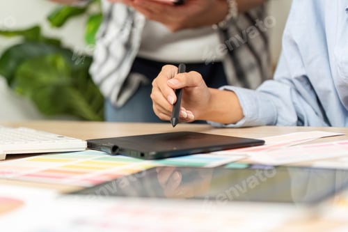 Preview: UX and UI Design Collaboration. Creative professionals brainstorming with digital tablet.
