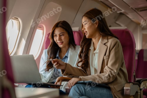 Preview: two beautiful businesswomen were traveling by plane