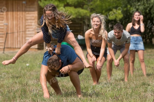 Preview: Friends playing leapfrog in park