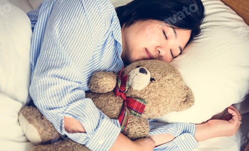 Preview: A woman in bed with a teddy bear