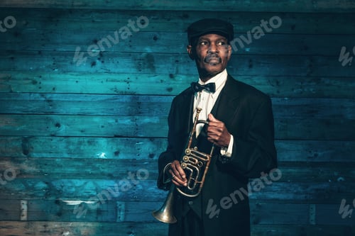 Preview: Vintage African American Senior Jazz Musician With Trumpet In Front Of Old Wooden Wall. Wearing