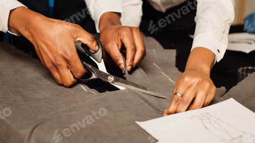 Preview: Team of tailors cutting material