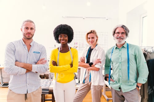 Preview: Stylish Tailors with Measuring Tapes in Design Studio