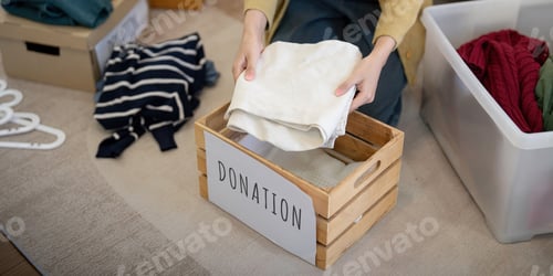 Preview: Donation, asian young woman sitting pack object at home, putting on stuff into donate box with