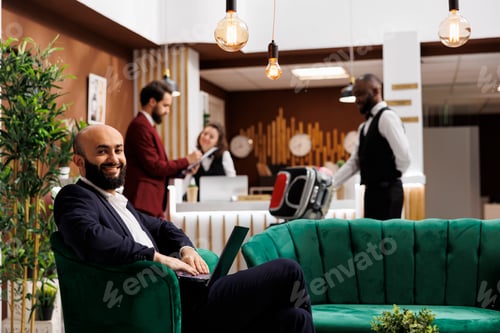 Preview: Businessman on laptop in lounge area