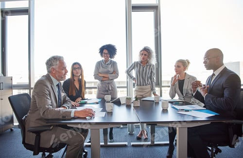 Preview: Diverse coworkers meeting together in a boardroom in an office