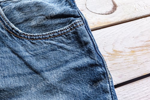 Preview: Close Up of Blue Jeans on Wood