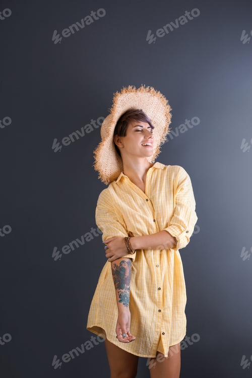 Preview: Trendy young woman with tattoo on color background