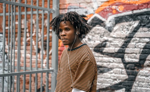 Preview: Portrait of young handsome dancing stylish black man with natural hair afro dreadlocks. Afroamerican