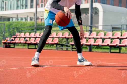 Preview: Tall guy basketball player with the ball shows his dribbling skills during practice