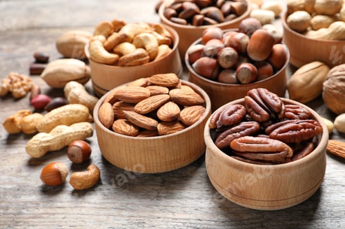 Preview: Bowls with organic nuts on wooden table. Snack mix