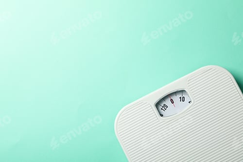 Preview: White scales on mint background. Weight loss concept