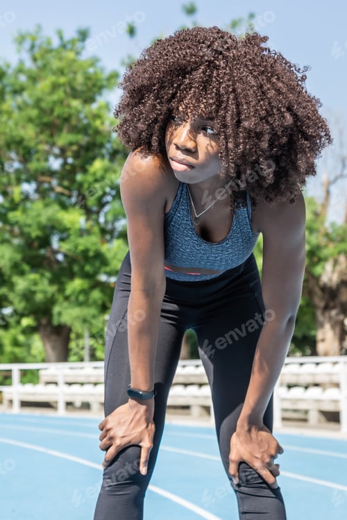 Preview: young black athlete girl with afro hair standing