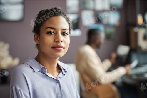 Preview: Professional Woman Poses in Office with Coworker