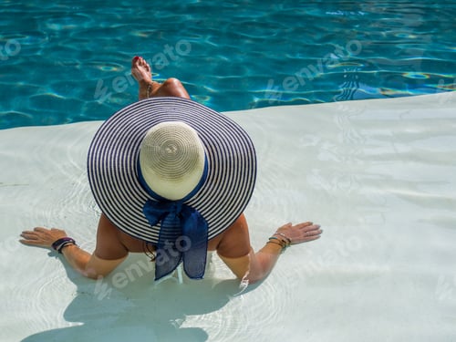 Preview: woman in luxury spa resort near the swimming pool.