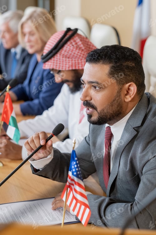 Preview: Confident mature businessman speaking in microphone