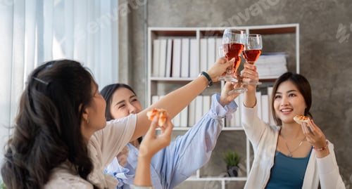 Preview: Group of Asian friends together to celebrate Christmas with champagne and eating pizza at home. Joy
